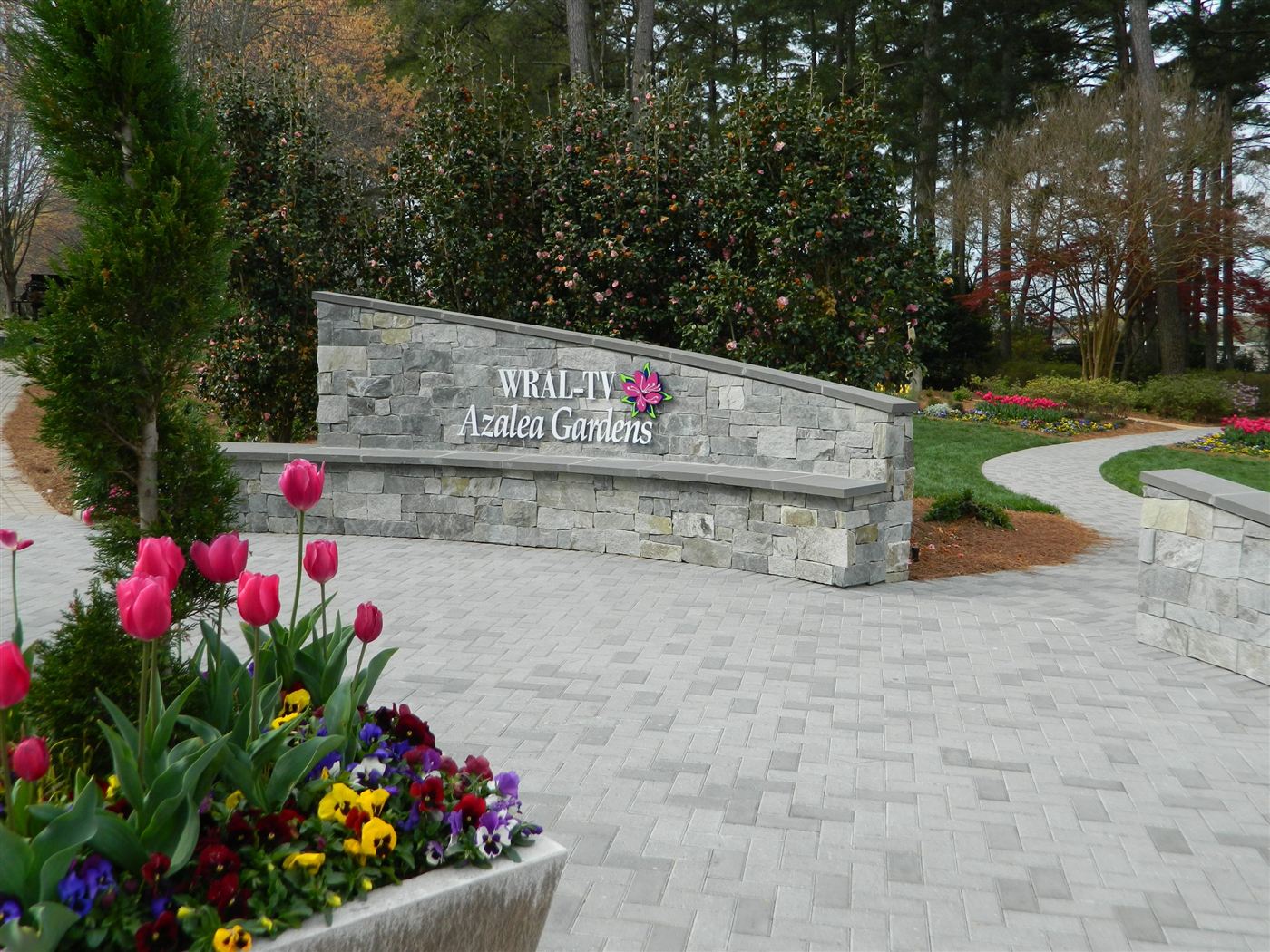 Stone garden sign among tulip beds at a Raleigh public azalea garden